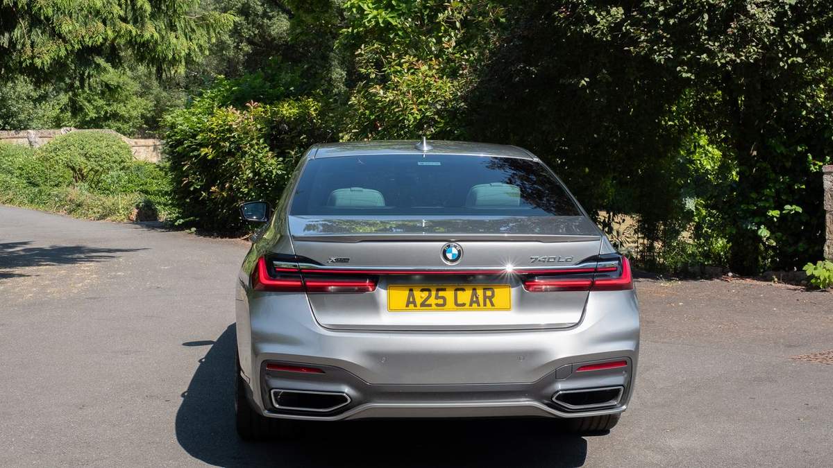 A25 Cars BMW 7 Series executive saloon rear view on Surrey lane